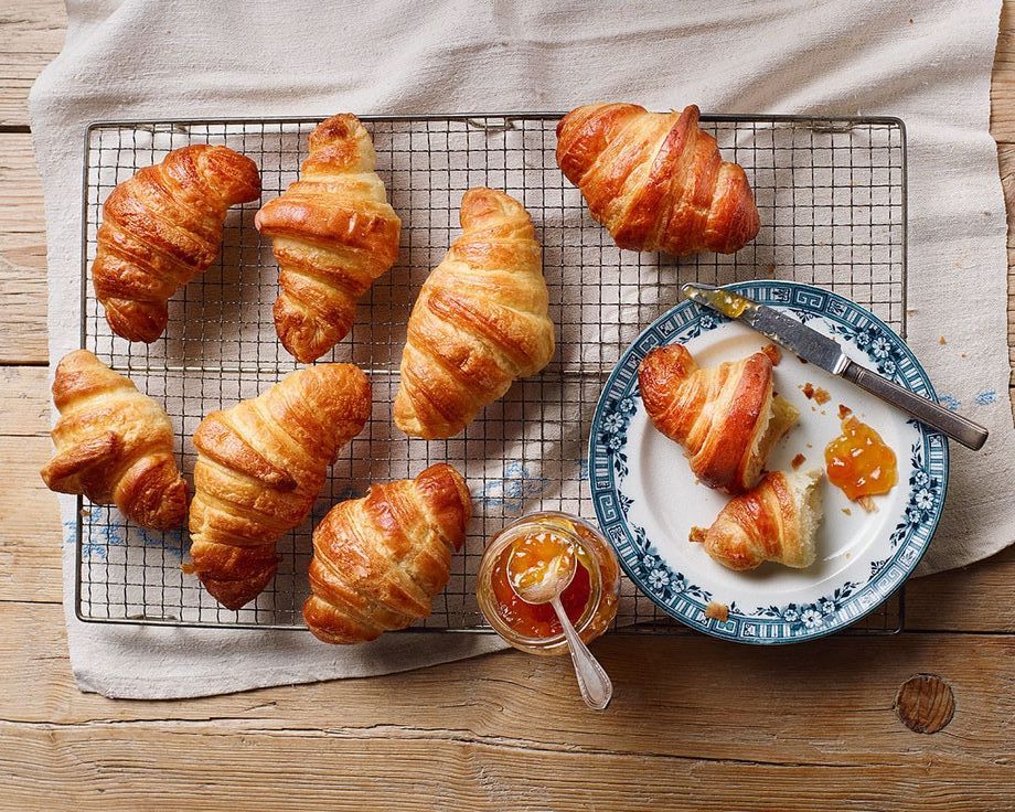 fresh croissants next to jam